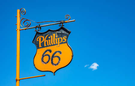 Amarillo, Texas USA. May 14, 2019. Phillips 66 vintage metal sign mounted on yellow pole, next to...