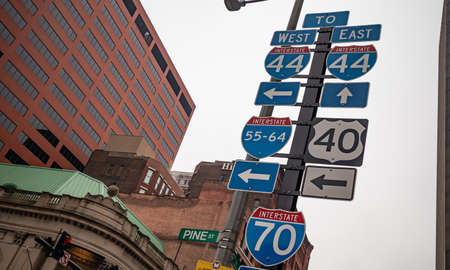 St Louis, USA. May 12, 2019. Traffic signs inform about the interstate roads. Arrows help the drivers to follow the direction they look for. Under low angle view.のeditorial素材