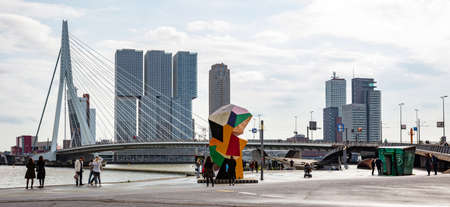 Rotterdam, Netherlands, October 13, 2019. People at the dock, Erasmus bridge against Rotterdam cityscape backgroundのeditorial素材