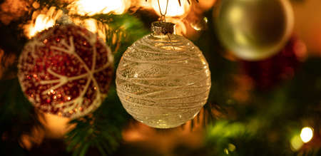 Christmas tree ornament decoration. Xmas balls hanging on a fir branch, closeup viewの写真素材