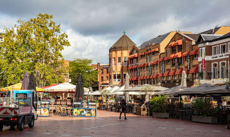Eindhoven, Netherlands. October 10, 2019. Restaurants and cafes located on a paved square. People walking around in a cloudy day looking for a place to relax.のeditorial素材