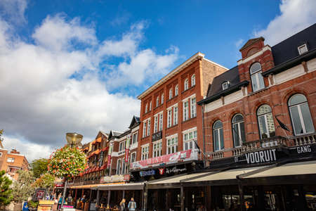 Eindhoven, Netherlands. October 10, 2019. Open-air cafe and restaurants in a row for a relaxing day. Autumn in the city with old buildings background.のeditorial素材
