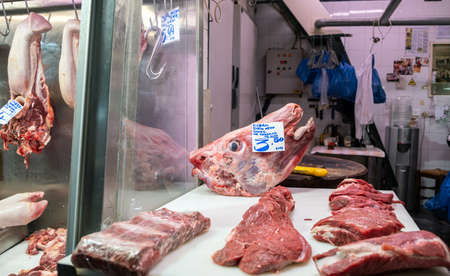 Athens, Greece. November 14, 2019. Uncooked beef steaks and head at a meat market stall. Central food market of the cityのeditorial素材