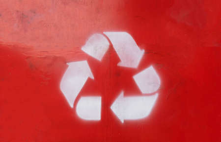Recycle symbol on red color background and three white arrows. Eco way to protect the environment of the planet.の写真素材