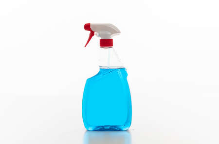 Cleaning spray bottle clear with red trigger isolated against white background. Chemical detergent blue color, sprayer product template, blank label, copy spaceの写真素材