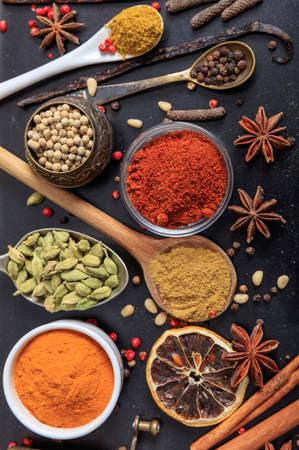 Spices and herbs seeds and ground flat lay, black color background, top view. Cooking food seasoningの写真素材