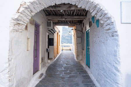 Traditional greek whitewashed buildings, cobblestone streets and stone structure arch in Ioulida village, Chora.の写真素材