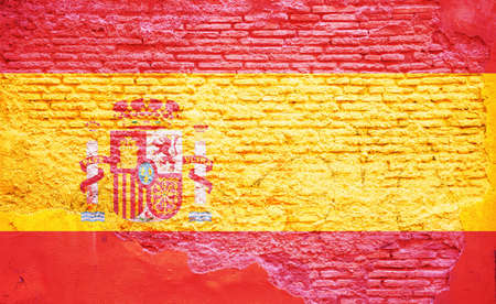 Spain flag on wall. Spanish flag painted on a grunge brick wall. Spain and Spanish language and culture conceptの写真素材