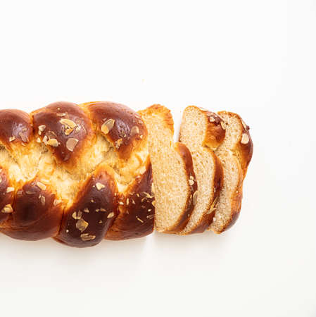 Sweet bread, easter tsoureki cozonac sliced isolated on white background, top view. Braided brioche, festive traditional challahの写真素材