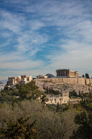 Athens, Greece. Acropolis and Parthenon temple, top landmark. Scenic view of ancient Greece remains from Philopappos or Filopappos Hill, cloudy blue sky, vertical.の素材 [FY310141148203]