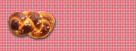 Sweet bread, easter tsoureki, cozonac on red checkered tablecloth background. Braided brioche,...