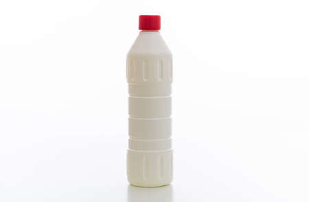Cleaning chlorine bleach bottle with red cap isolated against white background. Chemical household product for laundry and disinfection, no name template, copy spaceの写真素材