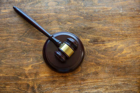 Law theme. Judge gavel on wooden office desk background, copy space, top view. Auction, court tableの写真素材
