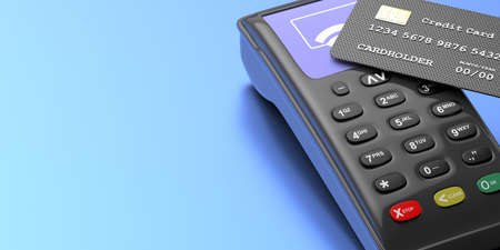 POS terminal, payment device and credit cards closeup on blue background. Shopping NFC bank payments...