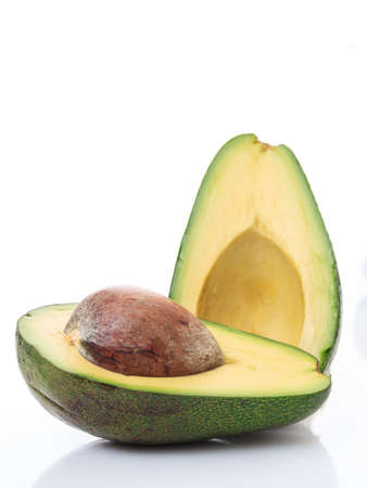 Healthy lifestyle concept. Avocado cut in two isolated on white background. Fresh, green fruit...