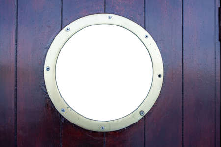 Ship porthole on brown wooden wall background. Round boat scuttle, empty blank white glass, mockup, template, copy spaceの写真素材