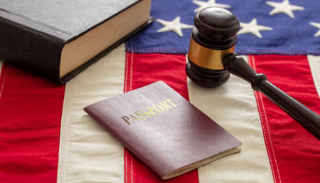 Passport and judge gavel on USA flag background, closeup view. Immigration, United States of America visa conceptの写真素材