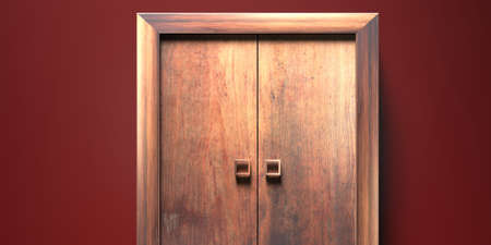 Wooden closed entrance door. Traditional, vintage door with knobs against bordeaux color wall...