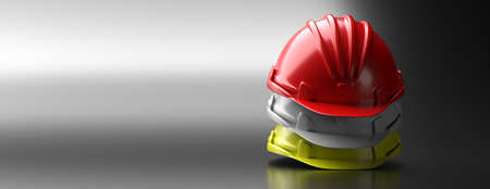 Work safety gear concept. Safety hardhats stack on gray background, copy space. Personal protective...