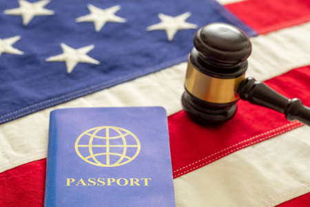 Blue passport and judge gavel on USA flag background, closeup view. Immigration, United States of America visa conceptの写真素材