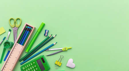 School supplies. Stationery on green color background, top view, copy space.  Education, Back to...