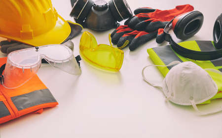 Work safety protection equipment flat lay. Industrial protective gear on white background, closeup view. Construction site health and safety conceptの写真素材