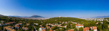 Athens Greece panorama. Athens city from Penteli mount, sunny summer day. Aerial view from droneの写真素材