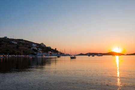 Kea Tzia island, Cyclades, Greece. Vourkari marina at sunset. Sailboats and sky, reflections on calm waterの写真素材