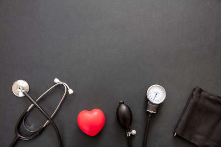 Blood pressure measure equipment, Hypertension control. Medical stethoscope and sphygmomanometer on black color background, top view.の写真素材