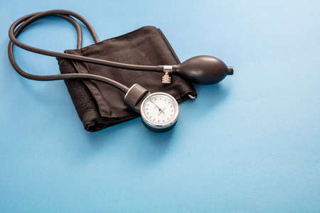Blood pressure measure, Hypertension control. Medical sphygmomanometer on blue color background,...
