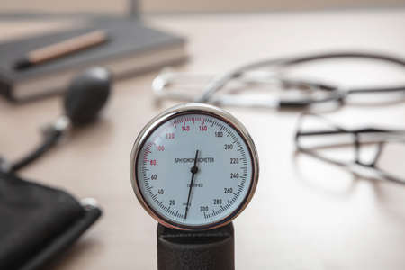 Blood pressure measure equipment, Hypertension control. Medical stethoscope and sphygmomanometer on doctor office desk, closeup view.の写真素材