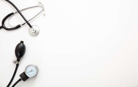Blood pressure measure equipment, Hypertension control. Medical stethoscope and sphygmomanometer on white color background, top view.の写真素材