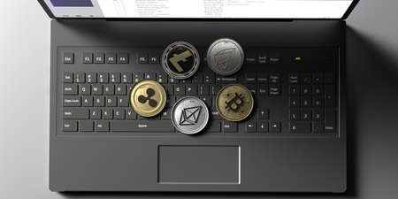 Cryptocurrency coins set on computer laptop background. Bitcoin, ripple, litecoin, eos, ethereum....