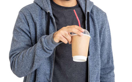Man with coffee. Body of young person wearing blue hooded sweatshirt with zip drinks fresh beverage...