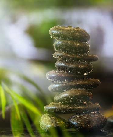 Buddhist meditation concept. Zen stones with water drops stacked on abstract background. Balance...