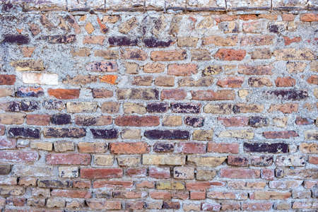 Old brown red color brick wall background and texture, closeup view. Exterior building weathered...