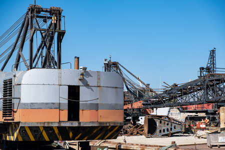 Old industrial ship boat parts in dry dock for repair, harbor of Drapetsona Piraeus Greece, blue sky, sunny day.の写真素材