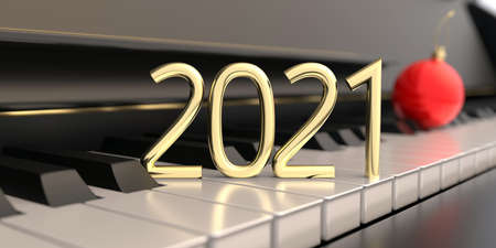 2021 new year golden number on piano keys, closeup view. Blur christmas red bauble on the keyboard,...