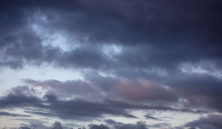 Sunset clouds. Dramatic magical sunrise cloudscape over blue gray color cloudy sky