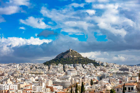 Mount Lycabettus and Athens cityscape view from Acropolis hill in Greece, blue cloudy sky, sunny dayのeditorial素材