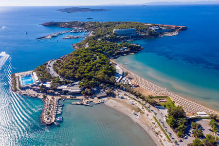 Athens Riviera, south coast, Greece. Asteras Vouliagmeni luxury resort hotel aerial drone view. Transparent turquoise sea water and sandy beach, sunny summer day.の写真素材