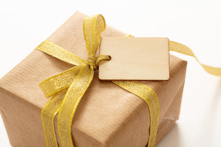 Blank tag on a gift box isolated on whiteの写真素材
