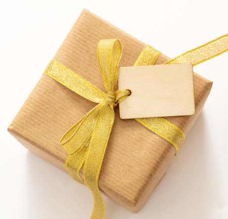 Blank tag on a gift box isolated on whiteの写真素材
