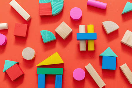 Children, creative preschool kids play. Wood toy block pieces and shapes flat lay. Wooden colorful...