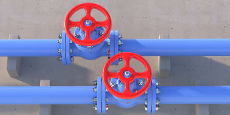 Water piping. Industrial metal pipelines blue color and valves with red wheels on concrete wall...