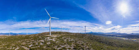 Wind turbines on the hill, aerial drone view. Wind farm panorama. Green ecological power energy...