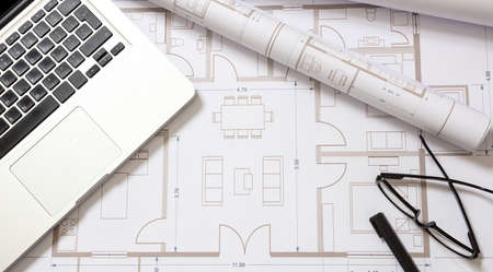 Building project blueprints and computer laptop, copy space. Architect engineer office desk. Digital drawings and designの写真素材