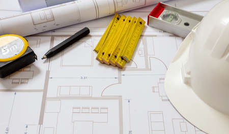 Project blueprints and architect enginerr hardhat white color, Housing project construction,...
