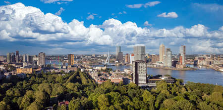 Rotterdam Netherlands cityscape and Erasmus bridge. Panoramic view from Euromast tower, sunny day, cloudy blue skyの写真素材