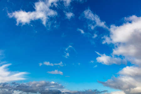 Cloudscape on blue sky background. Fluffy cumulus clouds white and grey color and empty sky, copy space, card template.の写真素材